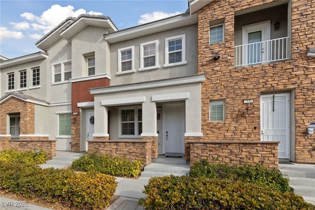 multi unit property featuring stone siding and stucco siding