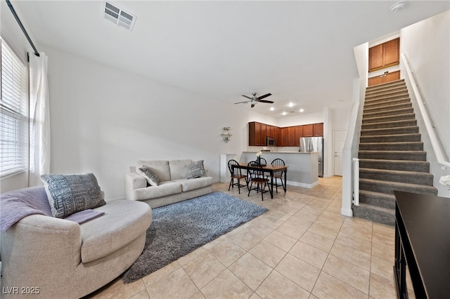living room featuring recessed lighting, visible vents, light tile patterned floors, stairs, and ceiling fan