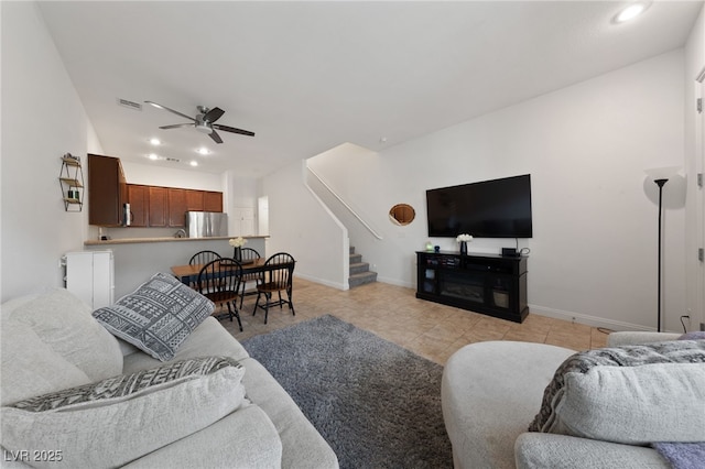 living room featuring light tile patterned flooring, baseboards, recessed lighting, a ceiling fan, and stairs