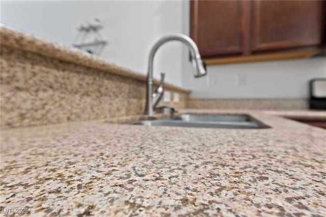 room details with a sink and light stone counters