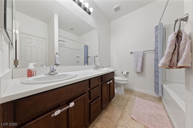bathroom featuring a sink, double vanity, toilet, baseboards, and visible vents
