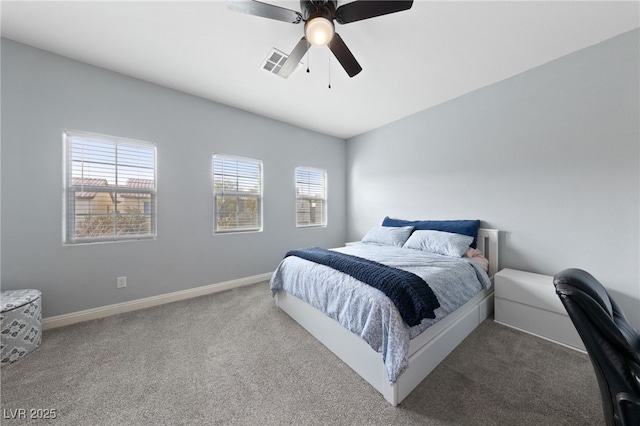 carpeted bedroom with ceiling fan, visible vents, baseboards, and multiple windows