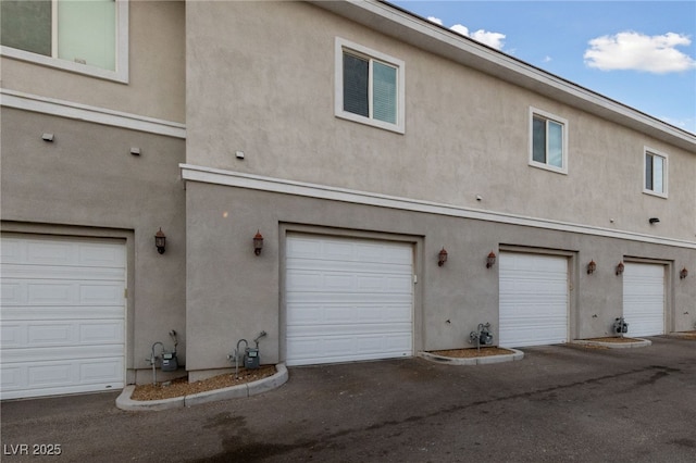 back of property featuring stucco siding