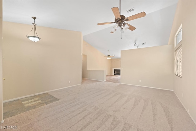 1805 Candle Bright Dr, Henderson, NV 89074 - unfurnished living room with ceiling fan, a fireplace, lofted ceiling, carpet flooring, and visible vents
