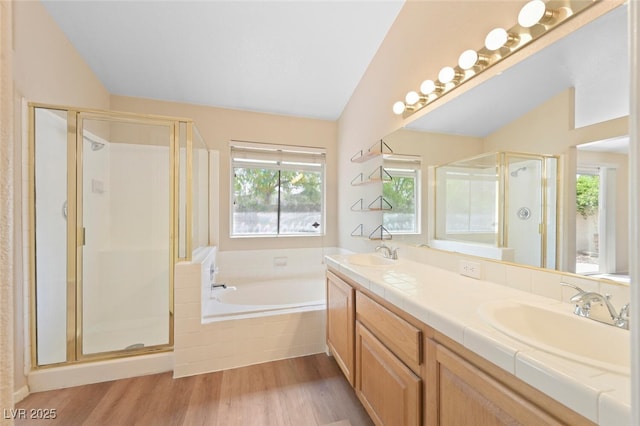 1805 Candle Bright Dr, Henderson, NV 89074 - bathroom featuring a garden tub, vaulted ceiling, a sink, and a stall shower