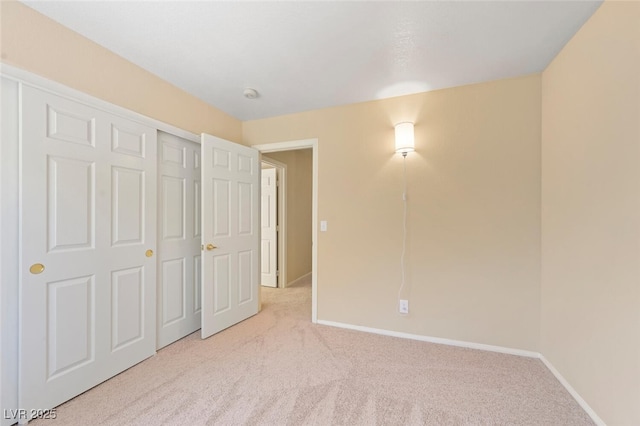 1805 Candle Bright Dr, Henderson, NV 89074 - unfurnished bedroom with baseboards, a closet, and light colored carpet