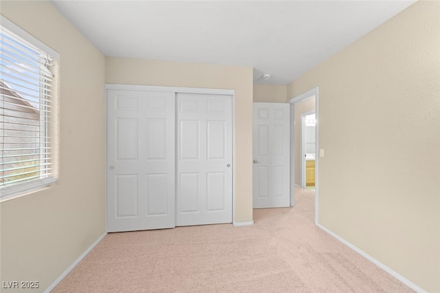 1805 Candle Bright Dr, Henderson, NV 89074 - unfurnished bedroom with baseboards, light colored carpet, and multiple windows