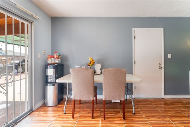 dining area with wood finished floors, baseboards, and an office area