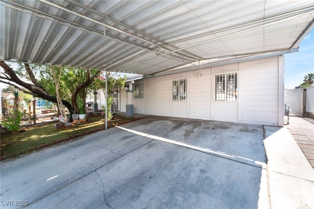 view of parking / parking lot with an attached carport