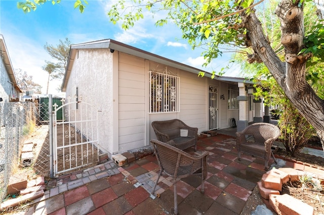 view of outbuilding featuring fence and a gate