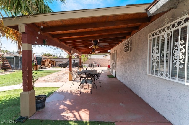 view of patio with ceiling fan, a fenced backyard, and outdoor dining area