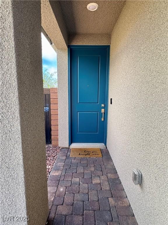 entrance to property with stucco siding