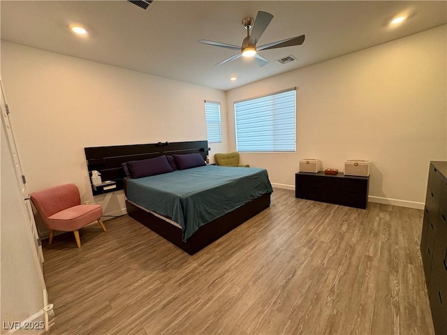 bedroom with wood finished floors, baseboards, a ceiling fan, and recessed lighting