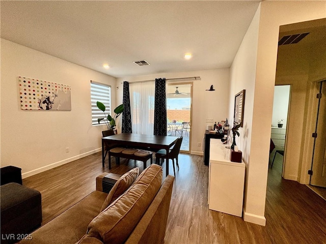 dining room with baseboards, wood finished floors, and recessed lighting