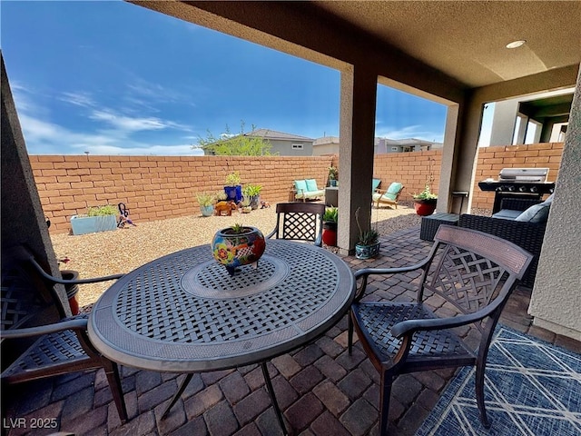 view of patio / terrace featuring outdoor dining space, a fenced backyard, and a grill