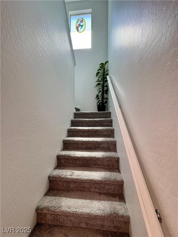 stairway with a textured wall