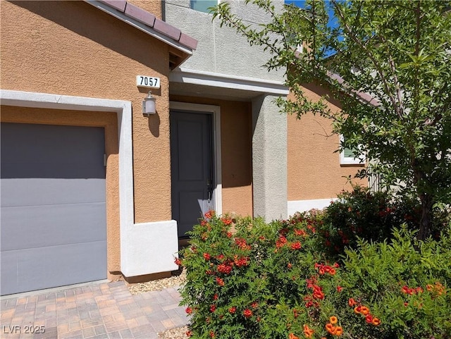 view of exterior entry with stucco siding