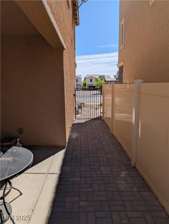 view of patio featuring fence and a gate