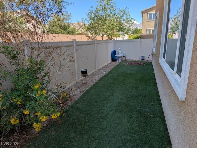 view of yard with a fenced backyard