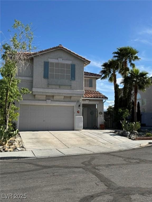 traditional-style house with stucco siding, concrete driveway, an attached garage, and a tile roof