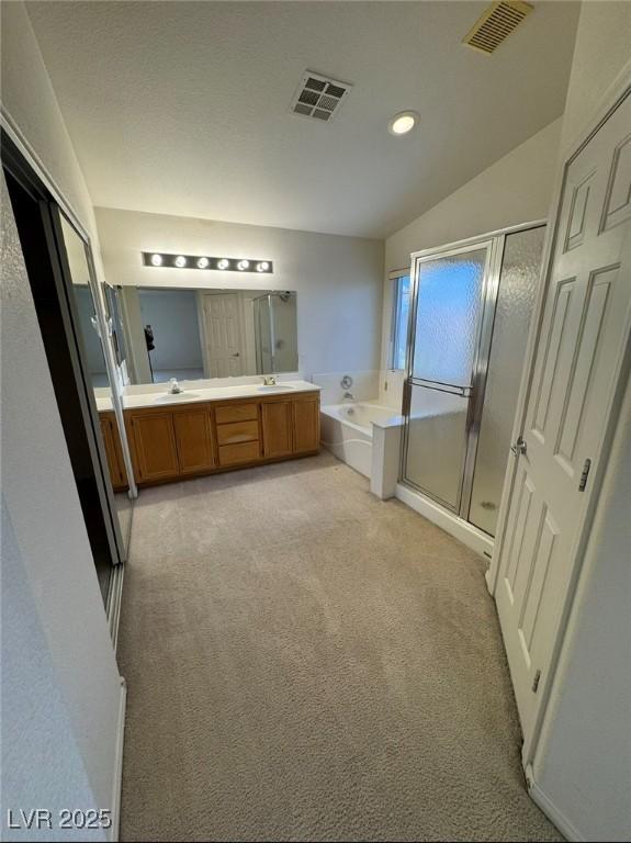 full bathroom with a sink, a bath, visible vents, and a shower stall