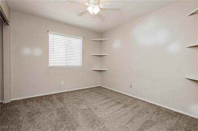 carpeted empty room with baseboards and ceiling fan