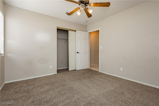 unfurnished bedroom with baseboards, ceiling fan, carpet, and a closet