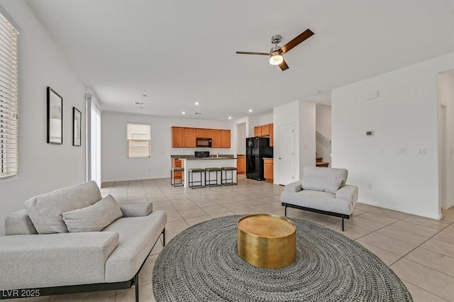 living room with recessed lighting, a ceiling fan, baseboards, and light tile patterned floors