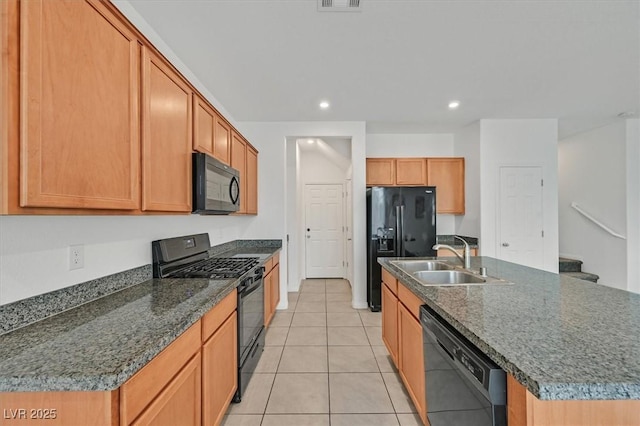 kitchen with a sink, black appliances, a kitchen island with sink, light tile patterned floors, and recessed lighting