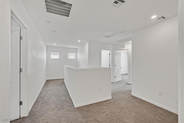 empty room with light carpet, baseboards, and visible vents