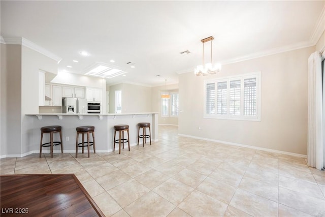 kitchen featuring white refrigerator with ice dispenser, a breakfast bar, light tile patterned floors, and ornamental molding