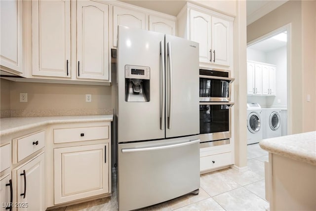 kitchen featuring light tile patterned floors, light countertops, separate washer and dryer, and white refrigerator with ice dispenser