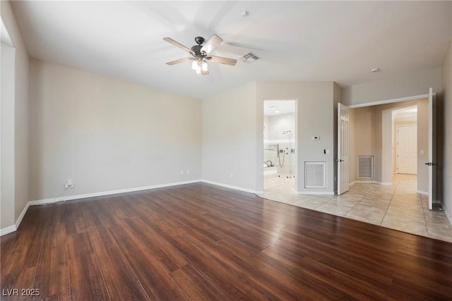 unfurnished room featuring wood finished floors, ceiling fan, visible vents, and baseboards
