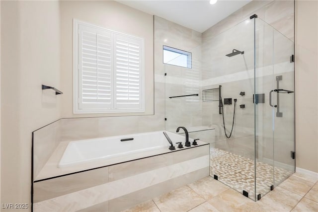 bathroom featuring a shower stall and a bath