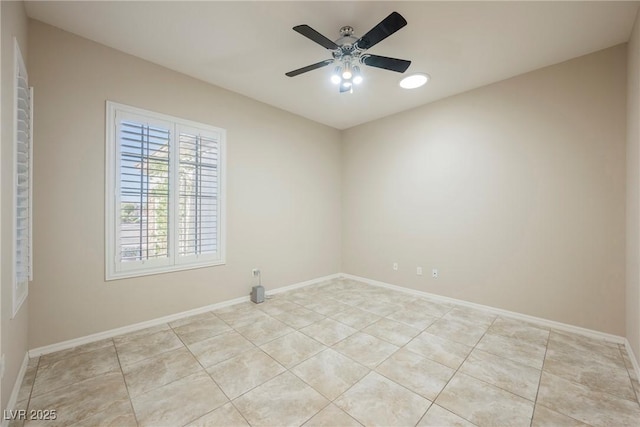 unfurnished room featuring light tile patterned flooring, a ceiling fan, and baseboards