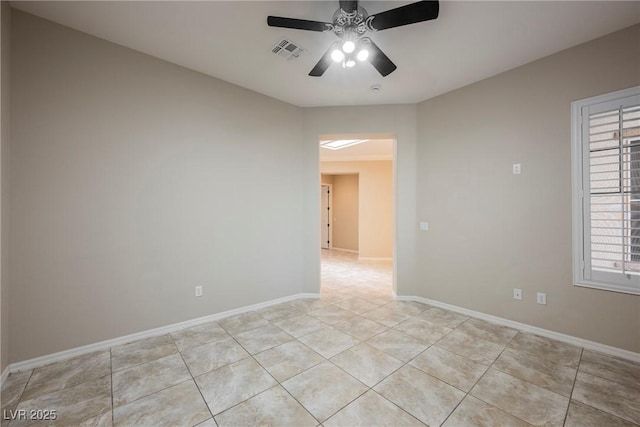 empty room featuring light tile patterned flooring, ceiling fan, baseboards, and visible vents