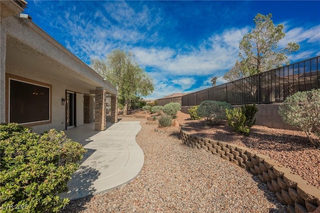 view of yard featuring a patio and a fenced backyard