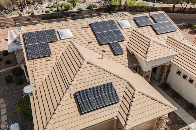 view of property exterior featuring fence and solar panels