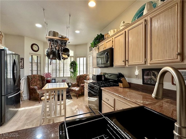 kitchen with recessed lighting, light wood-style flooring, light brown cabinetry, and black appliances