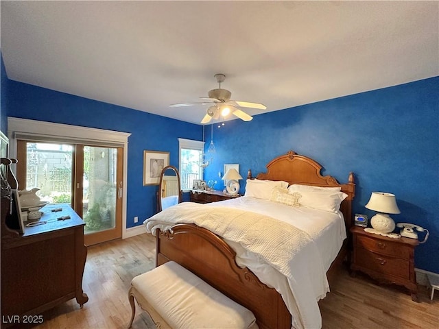 bedroom with baseboards, access to outside, a ceiling fan, and wood finished floors