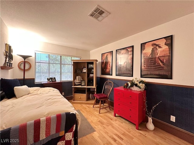 bedroom featuring visible vents and light wood-style flooring