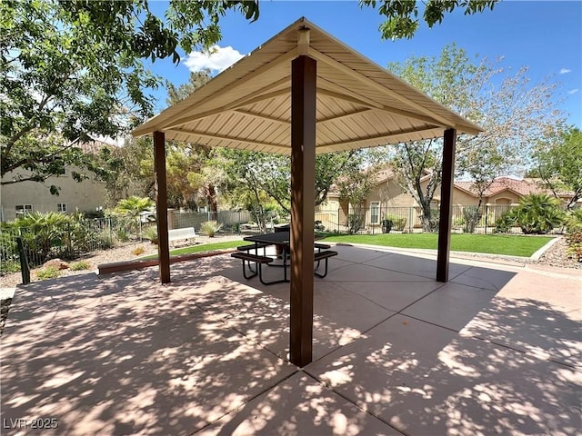 view of home's community with a lawn, a patio area, a gazebo, fence, and outdoor dining space