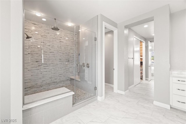 bathroom with recessed lighting, marble finish floor, a shower stall, and baseboards