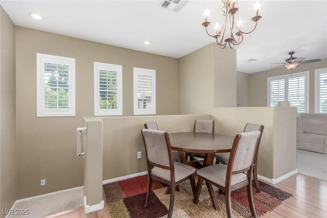 dining space featuring a wealth of natural light, visible vents, wood finished floors, and baseboards