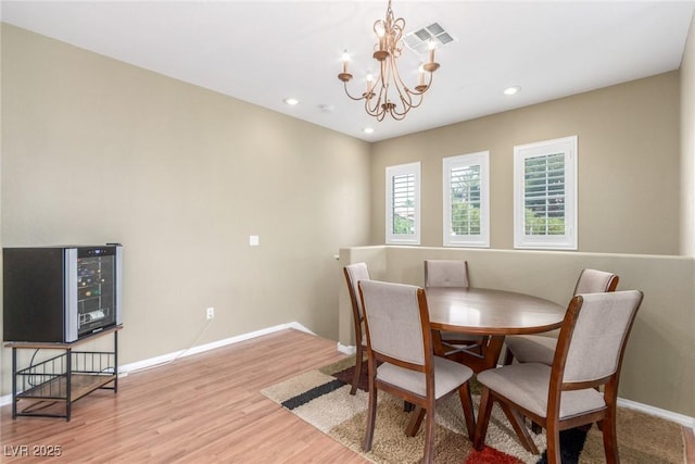 dining room featuring visible vents, baseboards, an inviting chandelier, recessed lighting, and light wood finished floors