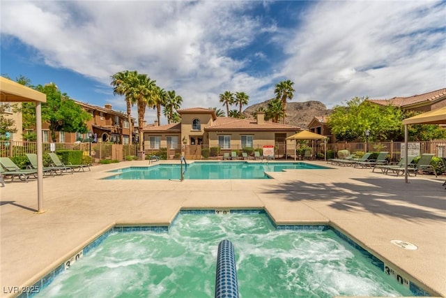 pool with fence, a gazebo, and a patio area