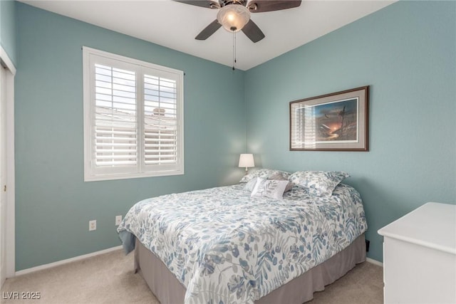 bedroom with baseboards, ceiling fan, and light colored carpet