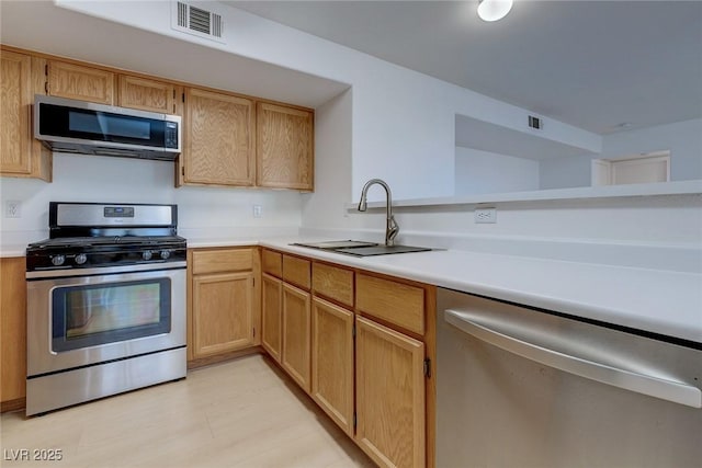 8450 Alta Dr Unit 136, Las Vegas, NV 89145 - kitchen with appliances with stainless steel finishes, visible vents, light countertops, and a sink