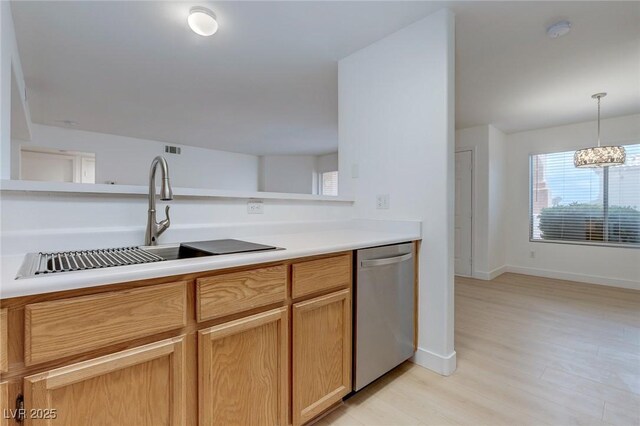 8450 Alta Dr Unit 136, Las Vegas, NV 89145 - kitchen with light wood finished floors, a sink, baseboards, light countertops, and dishwasher