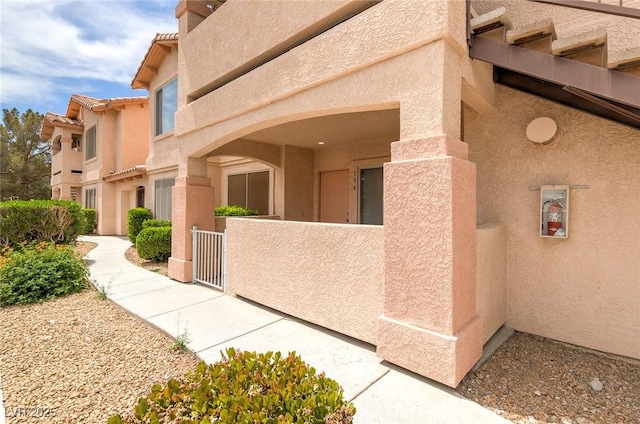 8450 Alta Dr Unit 136, Las Vegas, NV 89145 - view of side of home featuring a gate, fence private yard, and stucco siding